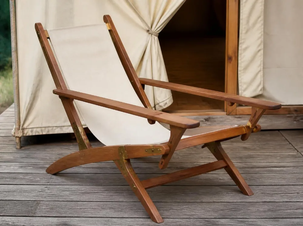 Nilgiri sling lounge chair in solid teak with brass fittings