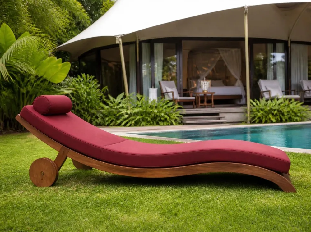 Tarkarli curved sun lounger in solid teak with brass fittings